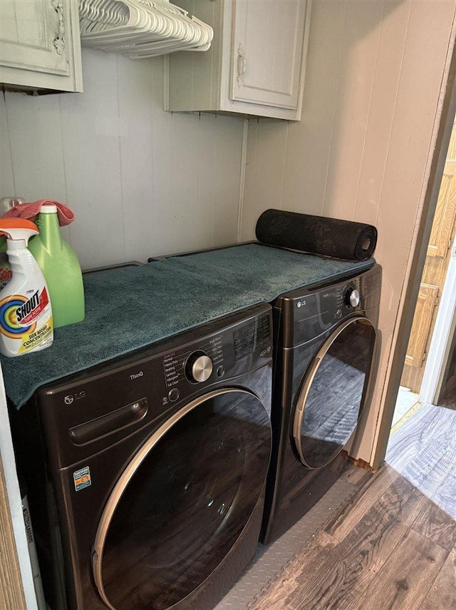 6515 Pincherry Rd, Charlevoix, MI 49720 - washroom with cabinet space, wood finished floors, and washer and clothes dryer