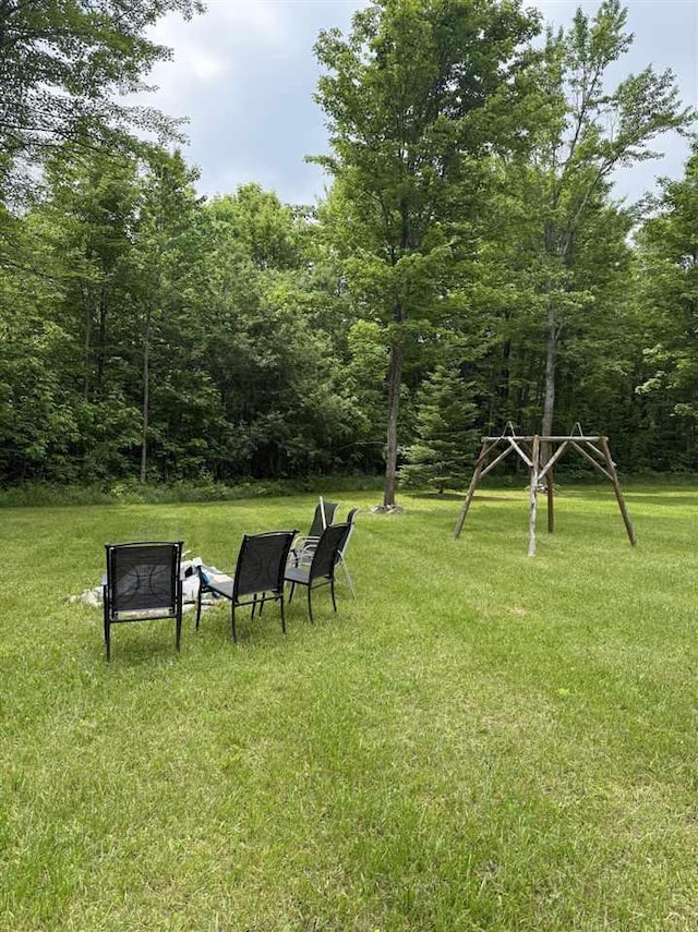 6515 Pincherry Rd, Charlevoix, MI 49720 - view of green lawn with a wooded view