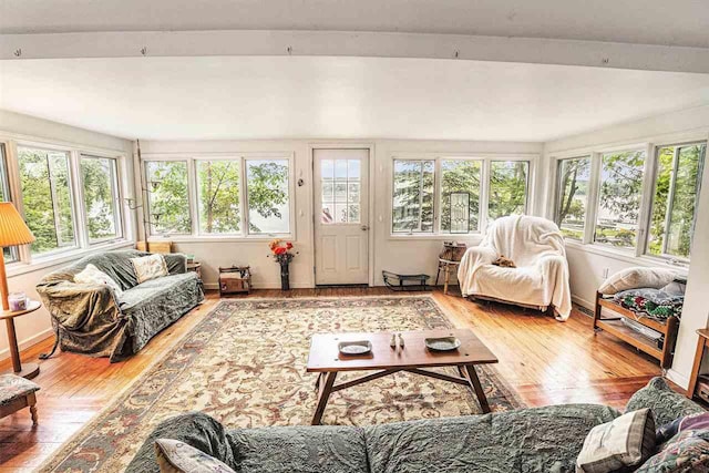 5272 Indian Garden Rd, Petoskey, MI 49770 - sunroom / solarium featuring hardwood / wood-style floors, beam ceiling, and a wooden deck