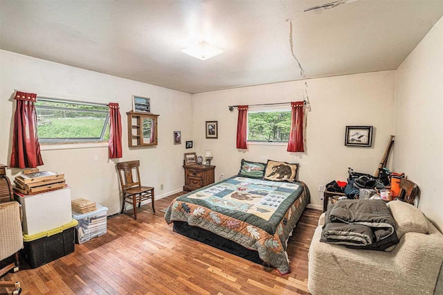 5272 Indian Garden Rd, Petoskey, MI 49770 - bedroom featuring hardwood / wood-style flooring and multiple windows