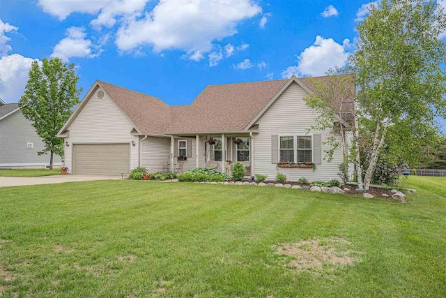 7879 Bay Meadow Dr, Harbor Springs, MI 49740 - view of front of property with a garage, driveway, a front yard, and roof with shingles