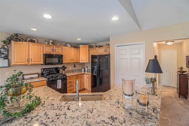 7879 Bay Meadow Dr, Harbor Springs, MI 49740 - kitchen featuring black appliances, light stone counters, light brown cabinets, light carpet, and recessed lighting