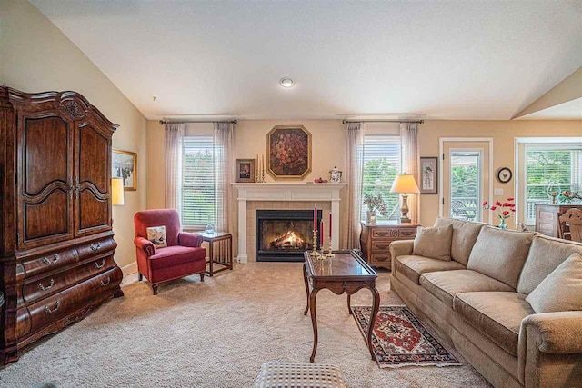 7879 Bay Meadow Dr, Harbor Springs, MI 49740 - carpeted living area featuring healthy amount of natural light, a tile fireplace, and lofted ceiling