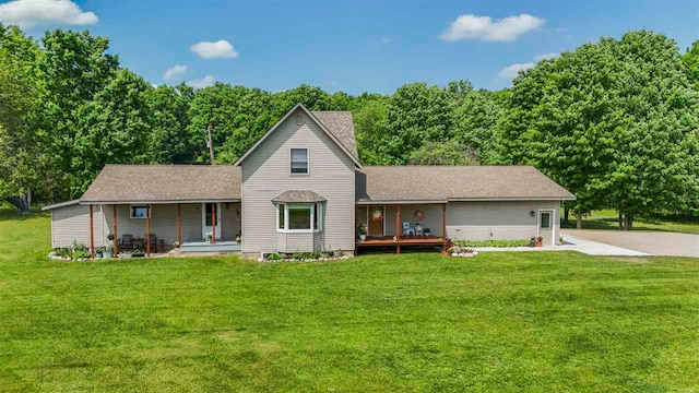 1922 Freeman Rd, East Jordan, MI 49727 - view of front of house with covered porch and a front lawn