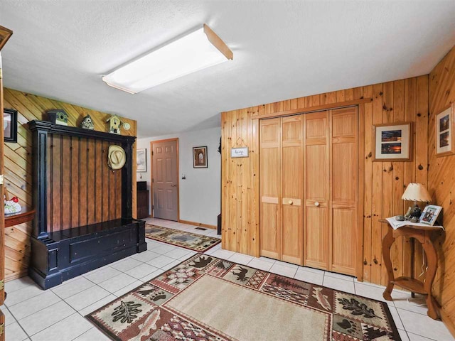 1922 Freeman Rd, East Jordan, MI 49727 - entrance foyer featuring wood walls and light tile patterned floors
