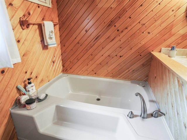1922 Freeman Rd, East Jordan, MI 49727 - full bathroom with wood walls and a tub to relax in