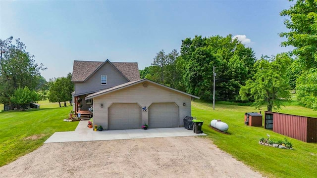 1922 Freeman Rd, East Jordan, MI 49727 - view of front facade with dirt driveway, a front yard, and an attached garage