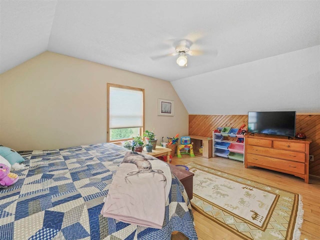 1922 Freeman Rd, East Jordan, MI 49727 - bedroom featuring vaulted ceiling, wood finished floors, wood walls, and ceiling fan