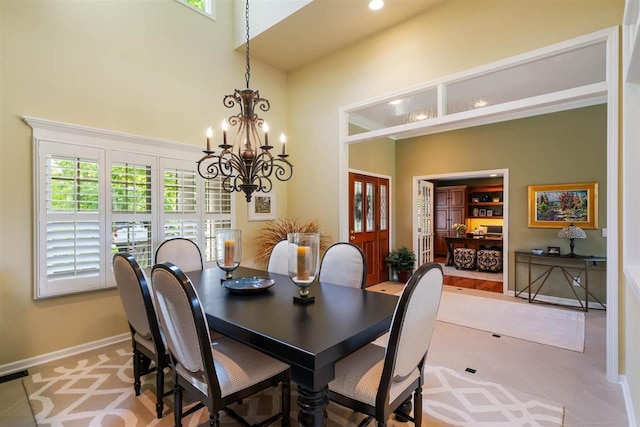 690 Woodhill Unit 6, Harbor Springs, MI 49740 - dining area with a towering ceiling, a chandelier, french doors, and recessed lighting