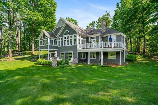 690 Woodhill Unit 6, Harbor Springs, MI 49740 - rear view of property with a sunroom, a chimney, a lawn, and a wooden deck