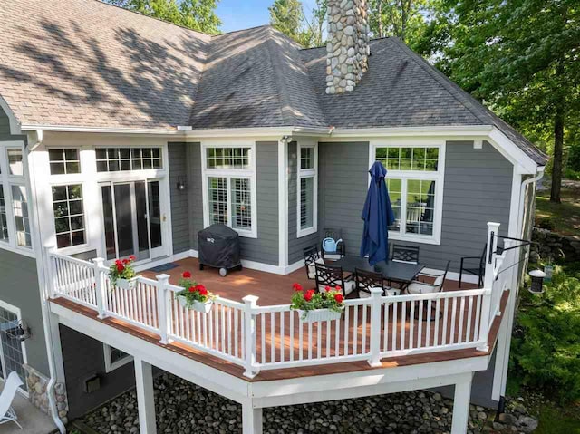 690 Woodhill Unit 6, Harbor Springs, MI 49740 - back of house with a chimney, a shingled roof, and a deck