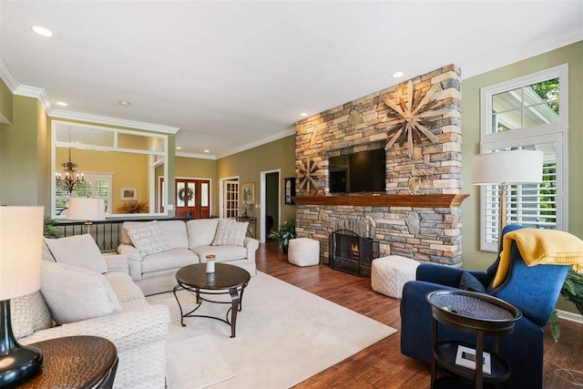 690 Woodhill Unit 6, Harbor Springs, MI 49740 - living area with wood finished floors, a chandelier, recessed lighting, ornamental molding, and a stone fireplace