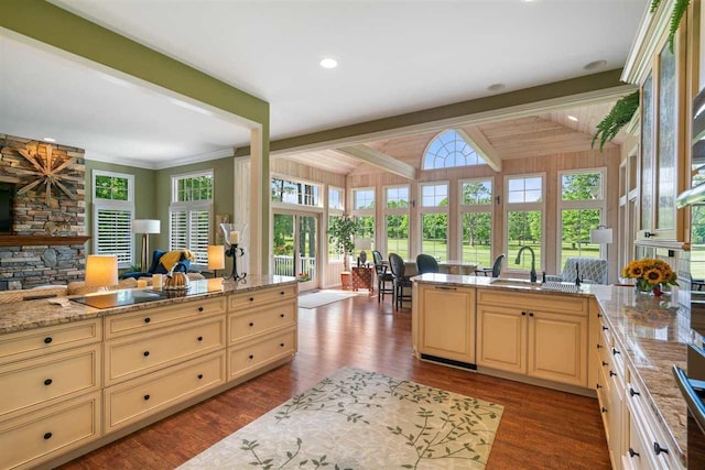 690 Woodhill Unit 6, Harbor Springs, MI 49740 - kitchen featuring cream cabinets, open floor plan, dark wood-style flooring, beam ceiling, and healthy amount of natural light