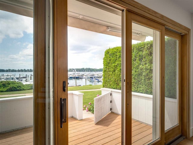 528 E Bay St Unit 30, Harbor Springs, MI 49740 - doorway featuring a water view, plenty of natural light, light wood-style floors, and view of marina