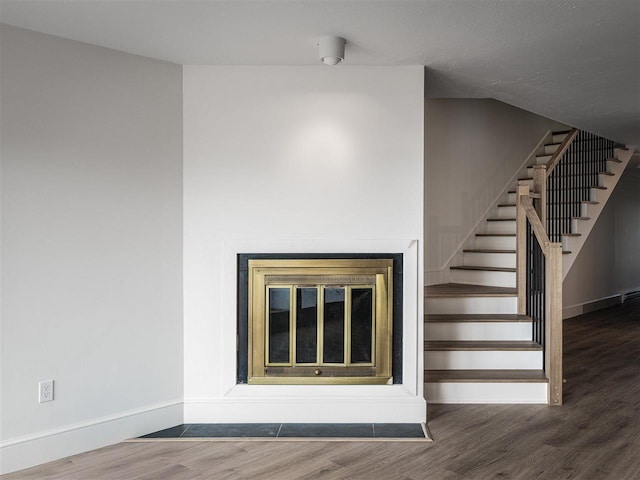 528 E Bay St Unit 30, Harbor Springs, MI 49740 - staircase featuring wood finished floors