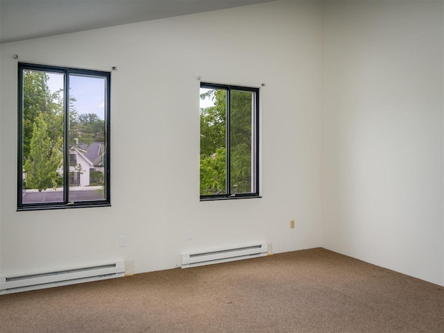 528 E Bay St Unit 30, Harbor Springs, MI 49740 - spare room with a baseboard radiator, carpet flooring, healthy amount of natural light, and vaulted ceiling