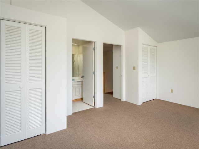 528 E Bay St Unit 30, Harbor Springs, MI 49740 - unfurnished bedroom featuring vaulted ceiling, carpet flooring, and ensuite bath