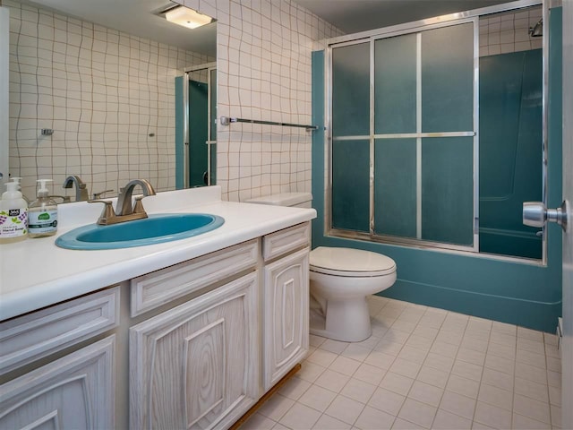 528 E Bay St Unit 30, Harbor Springs, MI 49740 - full bath featuring tile walls, vanity, tile patterned floors, and enclosed tub / shower combo