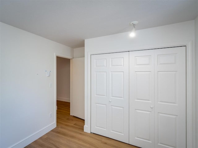 528 E Bay St Unit 30, Harbor Springs, MI 49740 - unfurnished bedroom featuring light wood-style floors and a closet