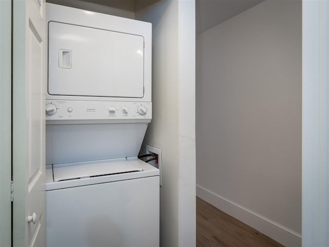 528 E Bay St Unit 30, Harbor Springs, MI 49740 - laundry room with stacked washer / drying machine and wood finished floors