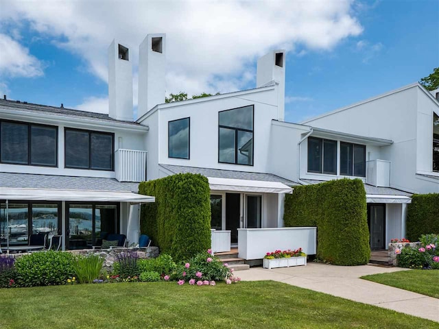 528 E Bay St Unit 30, Harbor Springs, MI 49740 - modern home with a front yard and stucco siding