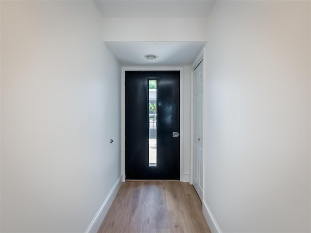528 E Bay St Unit 30, Harbor Springs, MI 49740 - doorway with light wood finished floors and baseboards