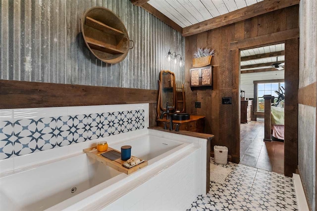 9235 Bailey Rd, East Jordan, MI 49727 - bathroom featuring wood walls, a wooden ceiling with exposed beams, and a tub with jets