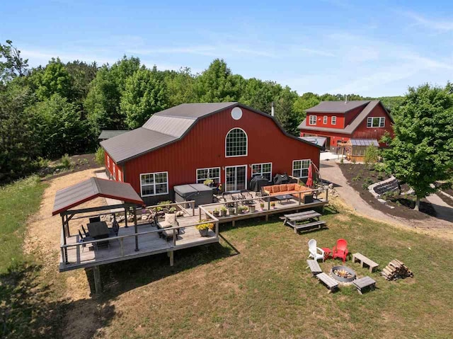 9235 Bailey Rd, East Jordan, MI 49727 - back of house with a barn, a fire pit, a yard, a gazebo, and a deck