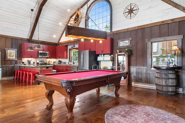 9235 Bailey Rd, East Jordan, MI 49727 - rec room with wood walls, hardwood / wood-style flooring, high vaulted ceiling, billiards table, and baseboard heating