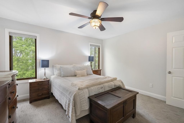 1185 Hideaway Valley Dr Unit 60, Harbor Springs, MI 49740 - bedroom with multiple windows, light carpet, and a ceiling fan