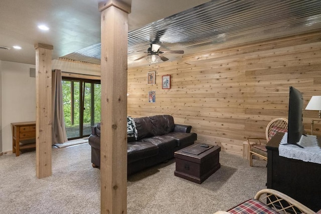 1185 Hideaway Valley Dr Unit 60, Harbor Springs, MI 49740 - living room featuring carpet floors, decorative columns, a ceiling fan, wooden walls, and recessed lighting