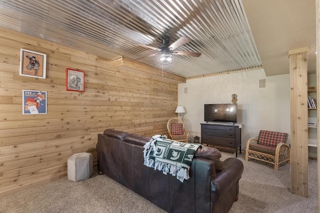 1185 Hideaway Valley Dr Unit 60, Harbor Springs, MI 49740 - living room with carpet, wood walls, and a ceiling fan