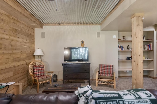 1185 Hideaway Valley Dr Unit 60, Harbor Springs, MI 49740 - carpeted living room with wooden walls, ceiling fan, and ornate columns