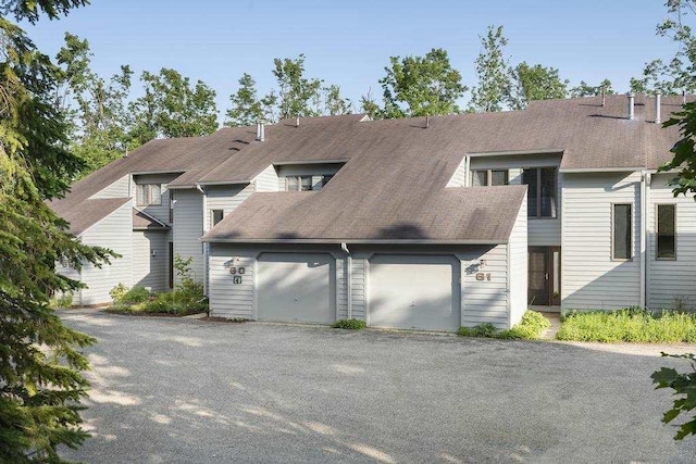 1185 Hideaway Valley Dr Unit 60, Harbor Springs, MI 49740 - view of front of property with an attached garage and driveway