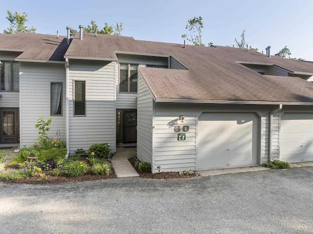 1185 Hideaway Valley Dr Unit 60, Harbor Springs, MI 49740 - multi unit property featuring roof with shingles and an attached garage