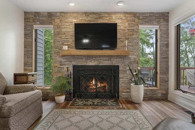 1185 Hideaway Valley Dr Unit 60, Harbor Springs, MI 49740 - living area featuring a fireplace and wood finished floors