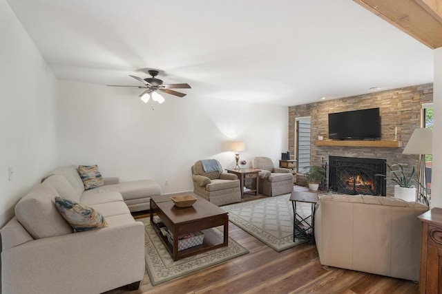 1185 Hideaway Valley Dr Unit 60, Harbor Springs, MI 49740 - living area featuring wood finished floors, a stone fireplace, and a ceiling fan