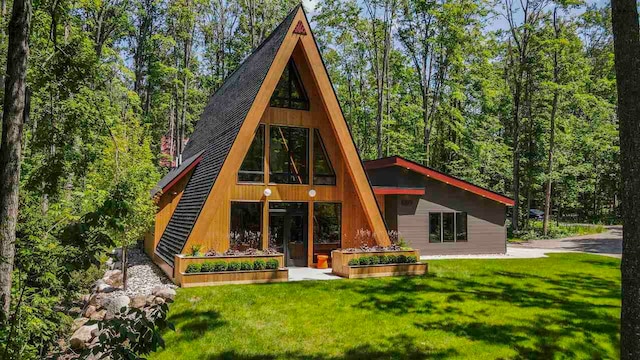 5277 Tyrol Ln, Harbor Springs, MI 49740 - back of property featuring a yard and a wooded view