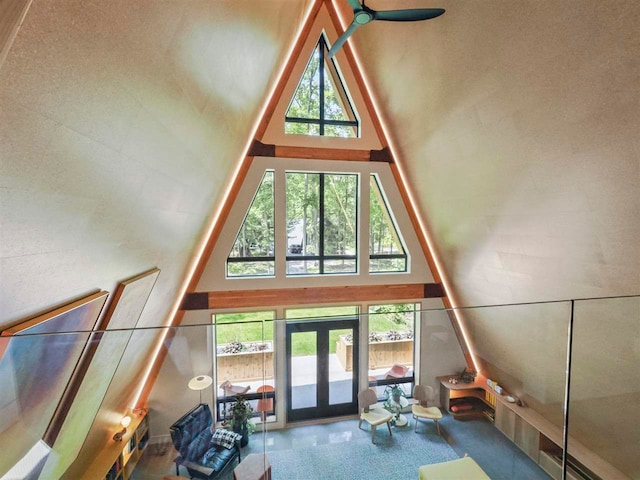 5277 Tyrol Ln, Harbor Springs, MI 49740 - unfurnished living room with a towering ceiling, healthy amount of natural light, carpet floors, and french doors