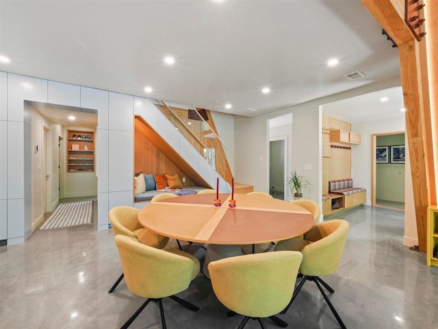 5277 Tyrol Ln, Harbor Springs, MI 49740 - dining space with stairway, concrete floors, and recessed lighting