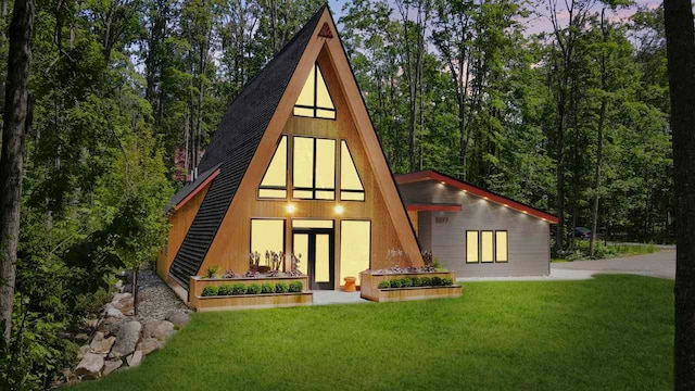 5277 Tyrol Ln, Harbor Springs, MI 49740 - rear view of house featuring a yard, roof with shingles, and a wooded view