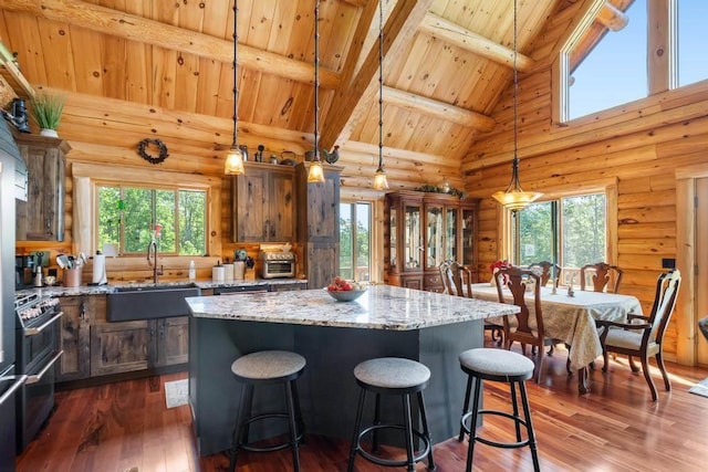 899 S State Rd, Harbor Springs, MI 49740 - kitchen featuring a wood ceiling with exposed beams, a center island, healthy amount of natural light, high vaulted ceiling, and log walls