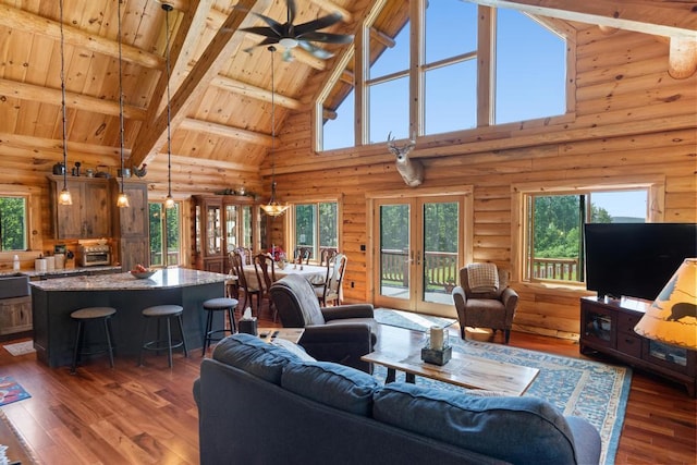 899 S State Rd, Harbor Springs, MI 49740 - living room with high vaulted ceiling, rustic walls, a wood ceiling with exposed beams, hardwood / wood-style floors, and healthy amount of natural light