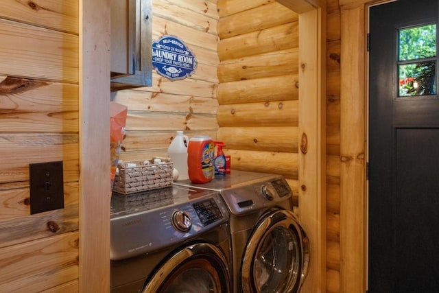 899 S State Rd, Harbor Springs, MI 49740 - washroom featuring log walls and washing machine and clothes dryer