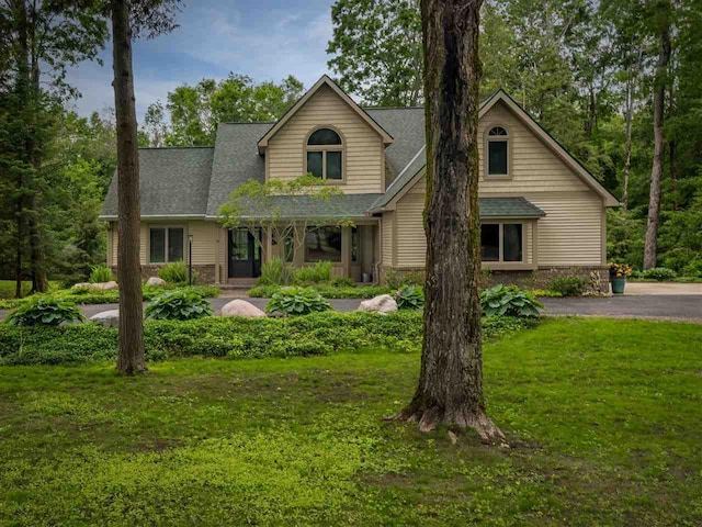 6598 Forest Way, Harbor Springs, MI 49740 - traditional-style home featuring a front yard and roof with shingles