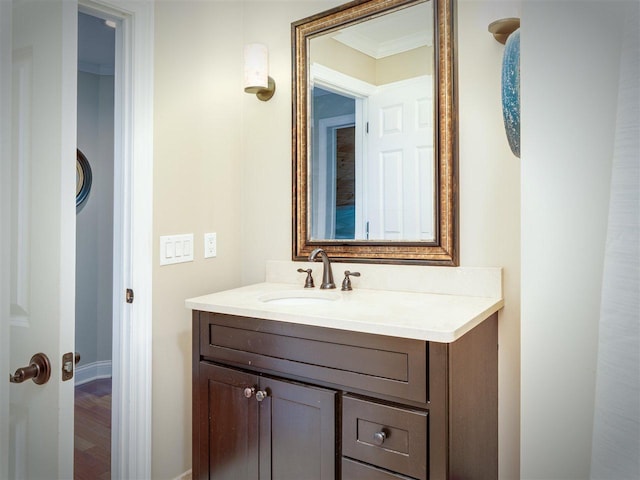 6598 Forest Way, Harbor Springs, MI 49740 - bathroom with vanity, ornamental molding, and wood finished floors
