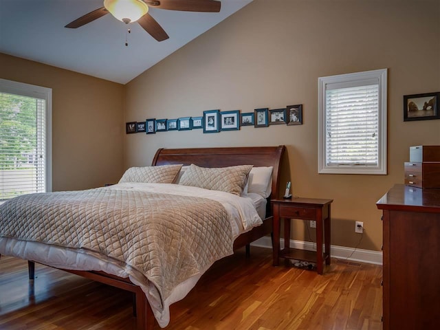 6598 Forest Way, Harbor Springs, MI 49740 - bedroom featuring vaulted ceiling, multiple windows, wood finished floors, and a ceiling fan