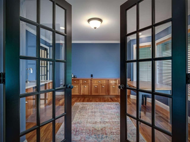 6598 Forest Way, Harbor Springs, MI 49740 - hallway featuring french doors, ornamental molding, and wood finished floors