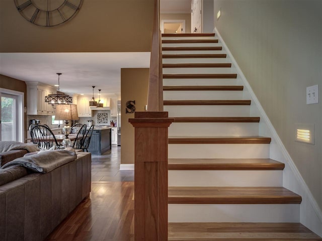 6598 Forest Way, Harbor Springs, MI 49740 - stairway featuring a chandelier and wood finished floors