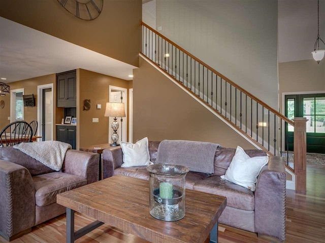 6598 Forest Way, Harbor Springs, MI 49740 - living room with a high ceiling, wood finished floors, and stairway
